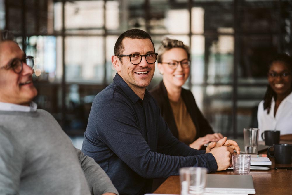 Colleagues talking and smiling